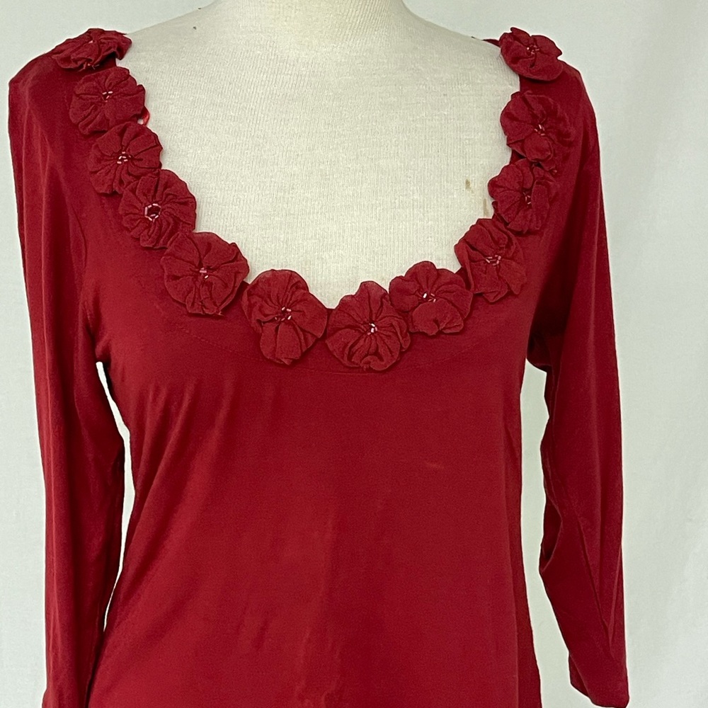 Red Shirt flowers around neckline Gently used .